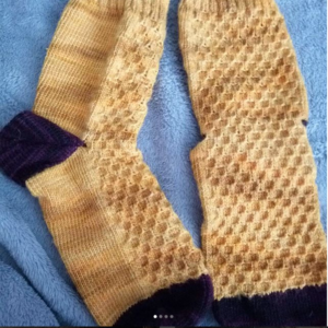 Pair of yellow hand-knit socks